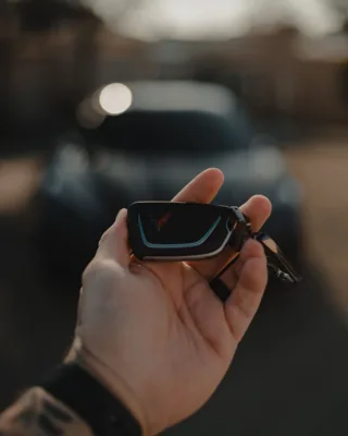 Reference photo of a smart car key fob held in a hand